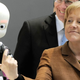 Image for article titled Why Is Angela Merkel Always Palling Around With Robots?